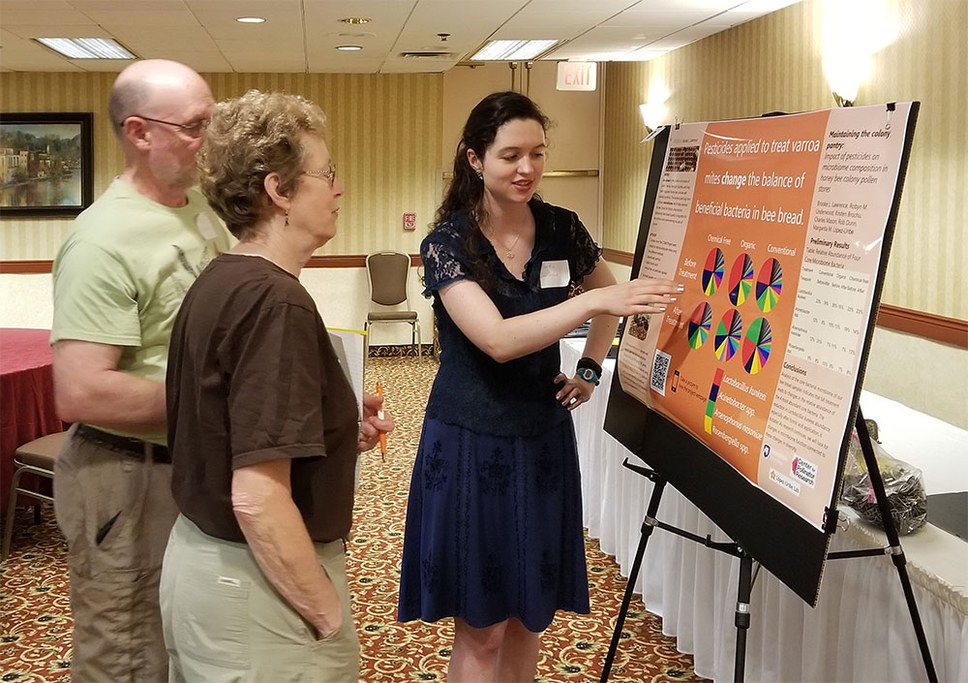 Brooke Lawrence presents her research poster titled “Maintaining The Colony Pantry: Impact Of Pesticides On Microbiome-Mediated Pollen Preservation In Honey Bee Colonies” to participants at the 2nd Pollinator In-service Meeting. Photo by Shelby Kilpatrick.