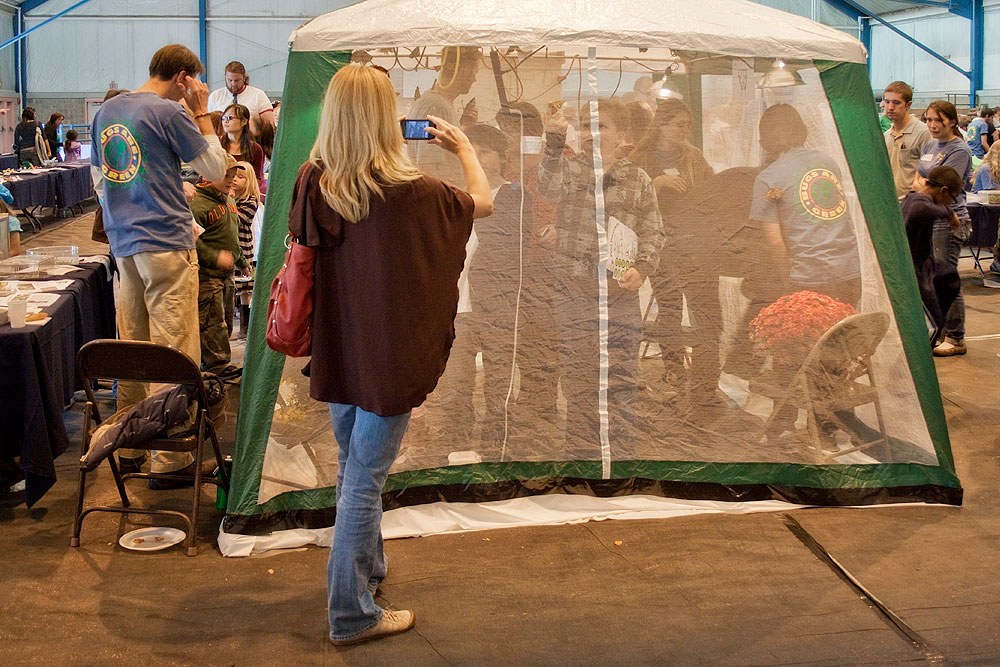 A parent takes pictures outside the butterfly tent. Photo by Nick Sloff