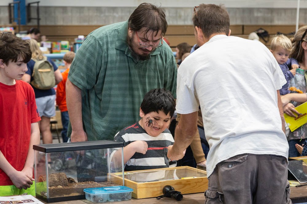 A father and son enjoy displays at the annual Great Insect Fair